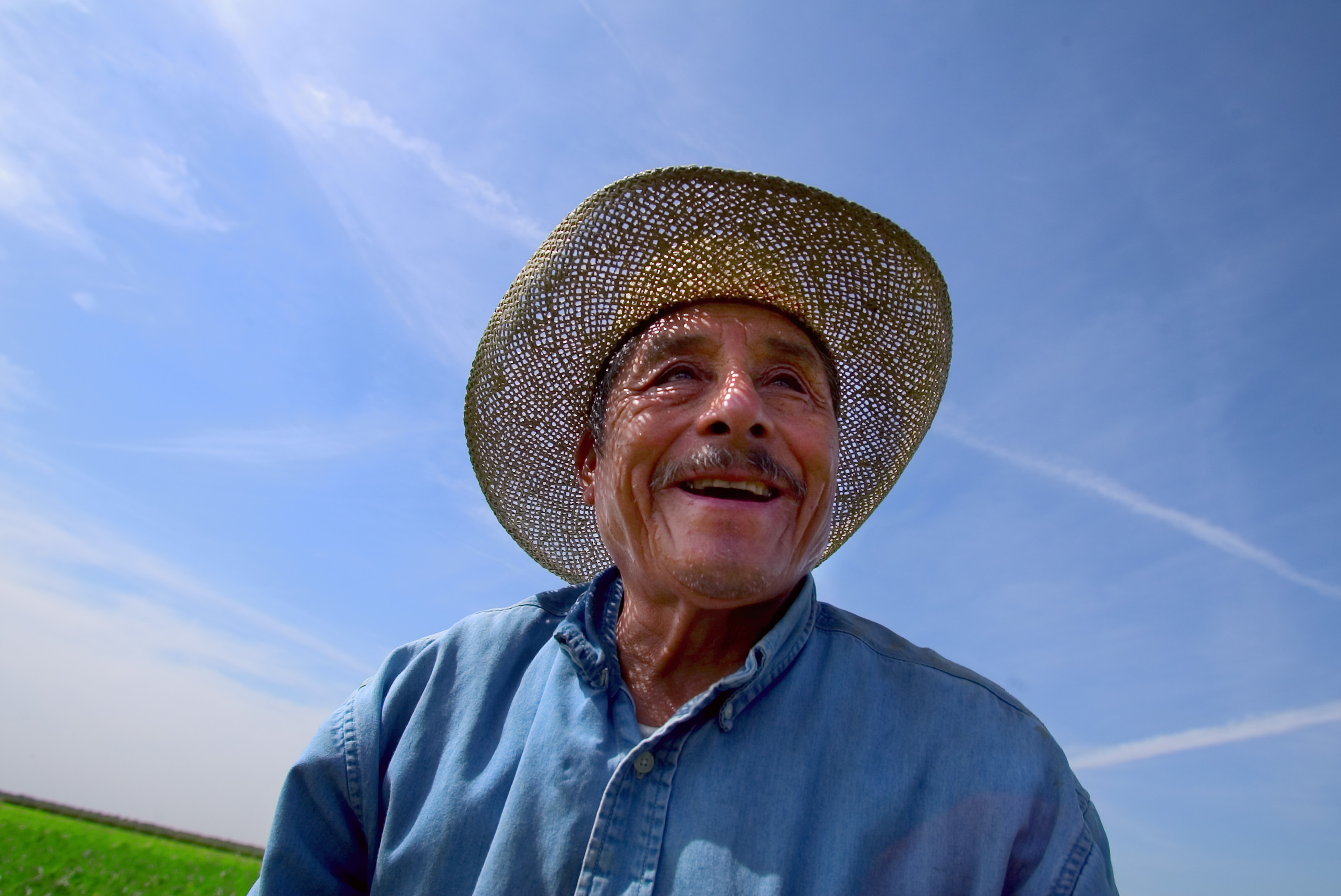 A man smiles in a field near Fresno, California. 2007