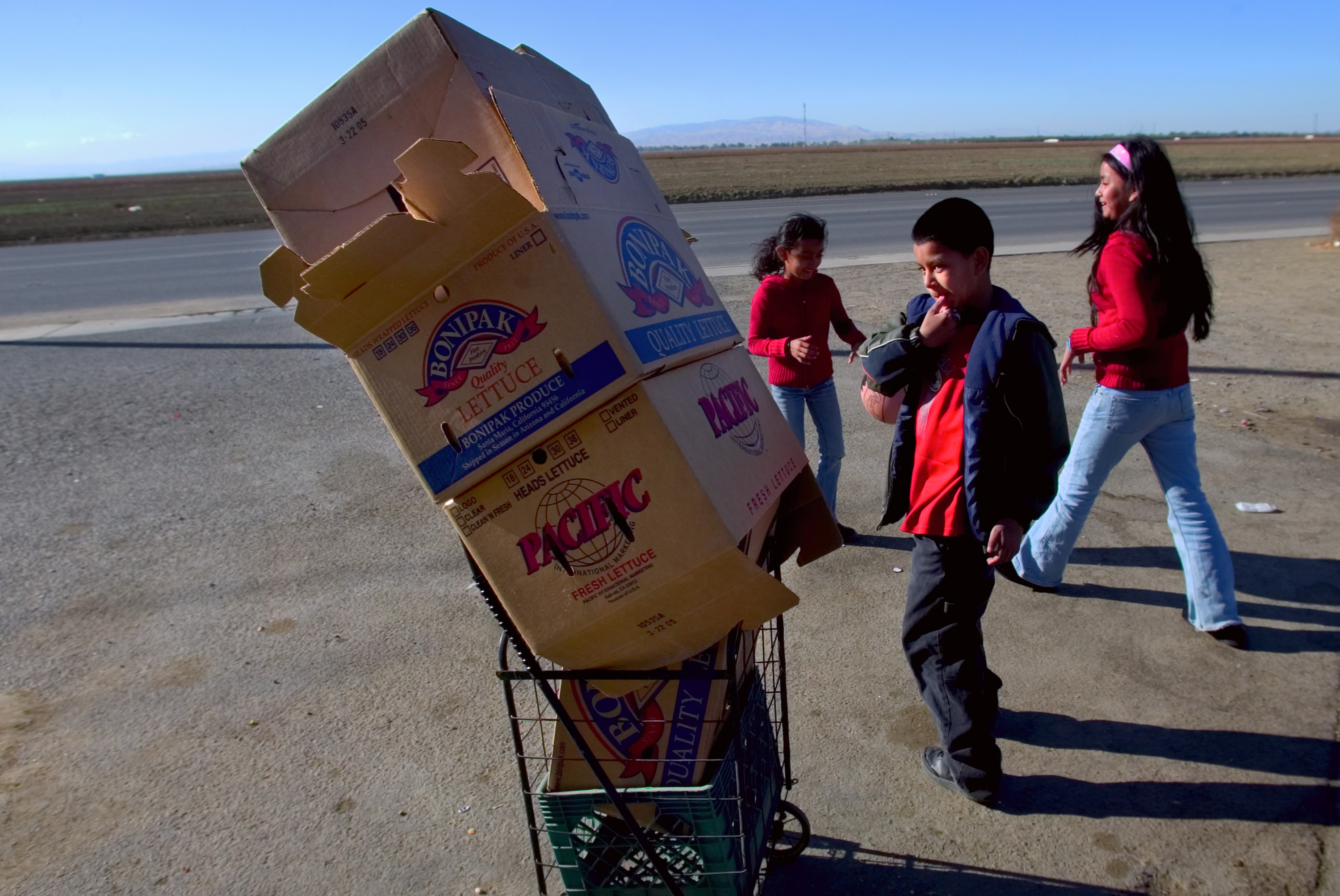 Children play with produce boxes in Huron, California. 2007