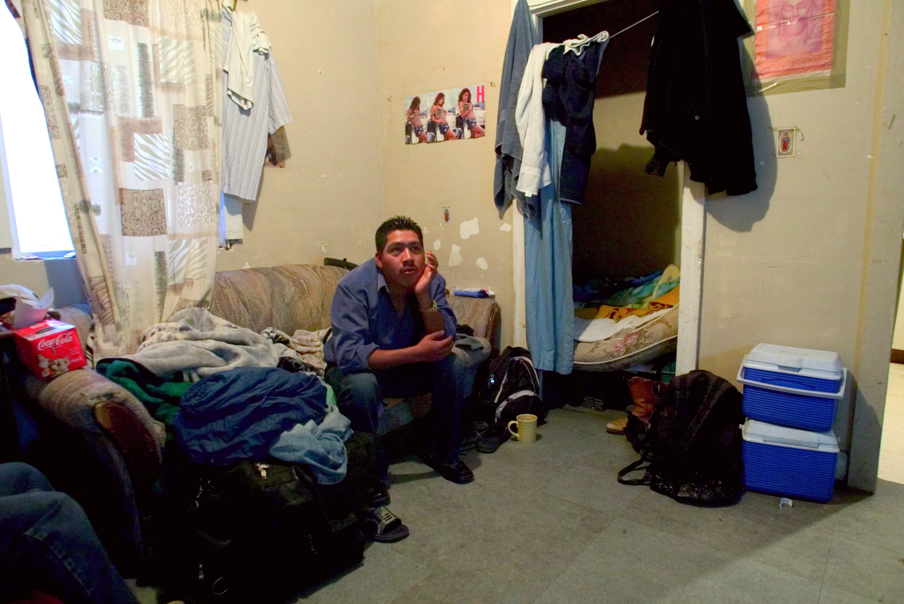 A man who goes by Rigo, sits in his room in Huron, California. 2007